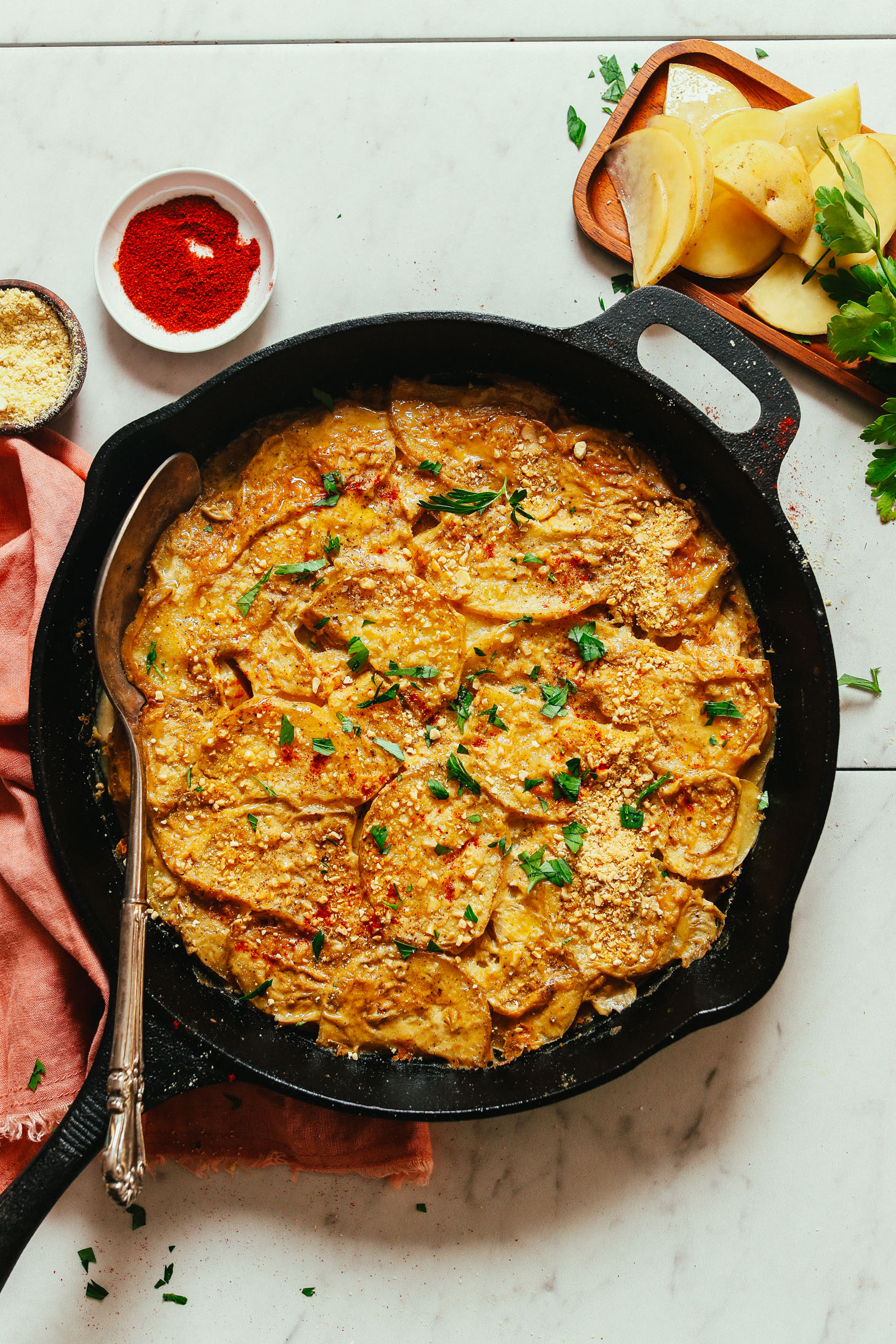 Cast-iron skillet filled with our Vegan Scalloped Potatoes recipe