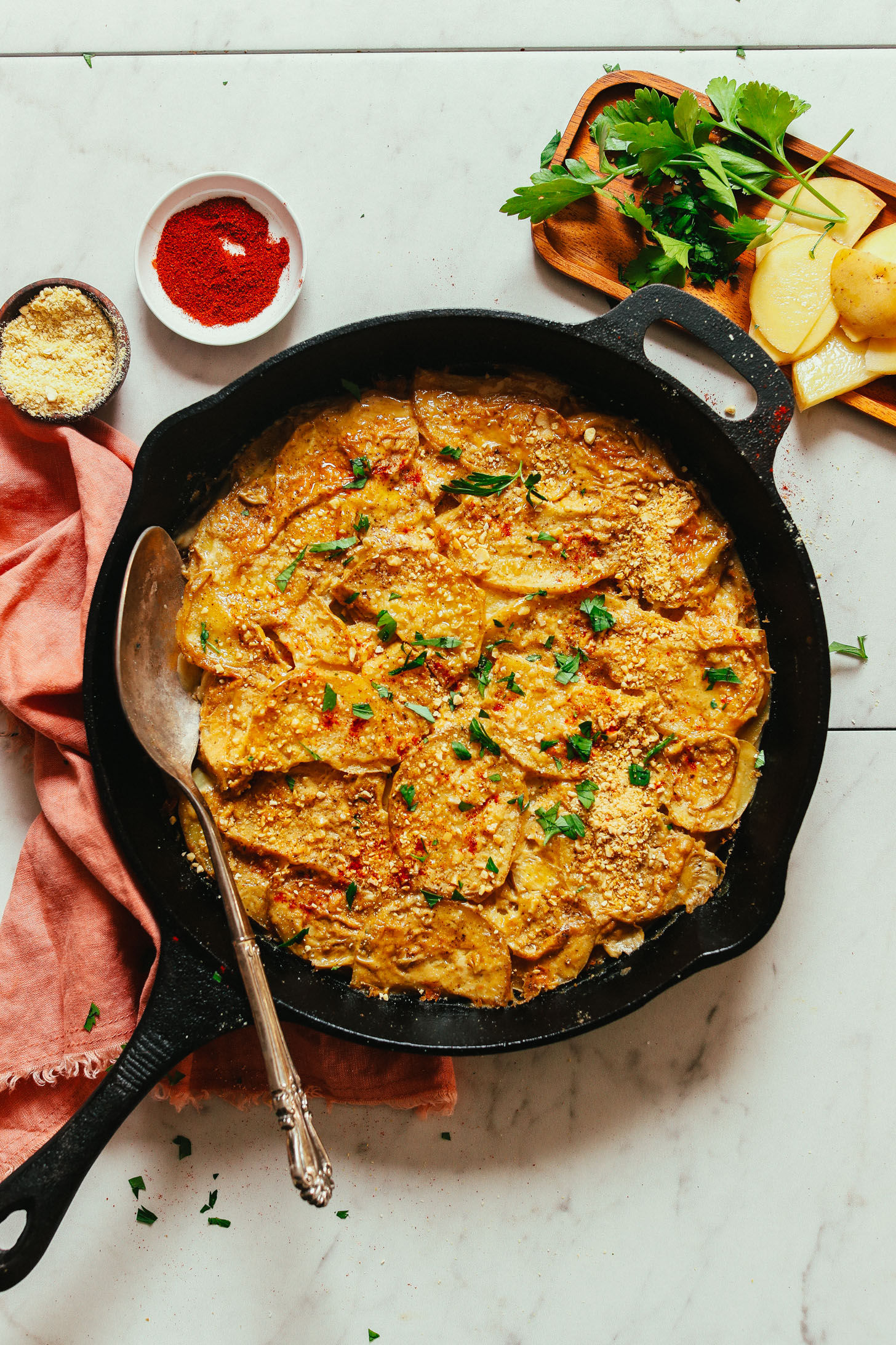 Cast-iron skillet filled with a batch of our Vegan Scalloped Potatoes recipe