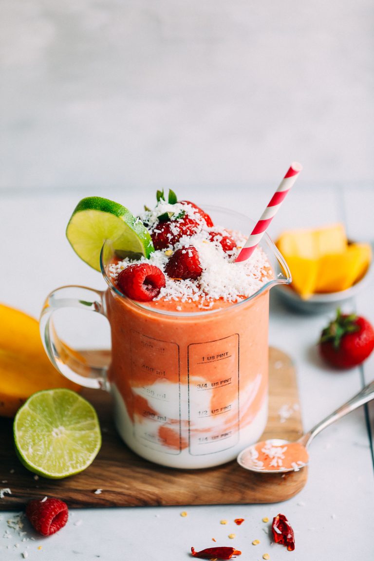 Beaker measuring glass filled with our Gingery Mango Berry Smoothie recipe