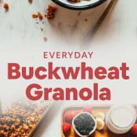 Buckwheat granola in breakfast bowls with fresh fruit and dairy-free milk