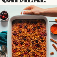 Holding a baking dish filled with our wholesome pumpkin baked oatmeal recipe