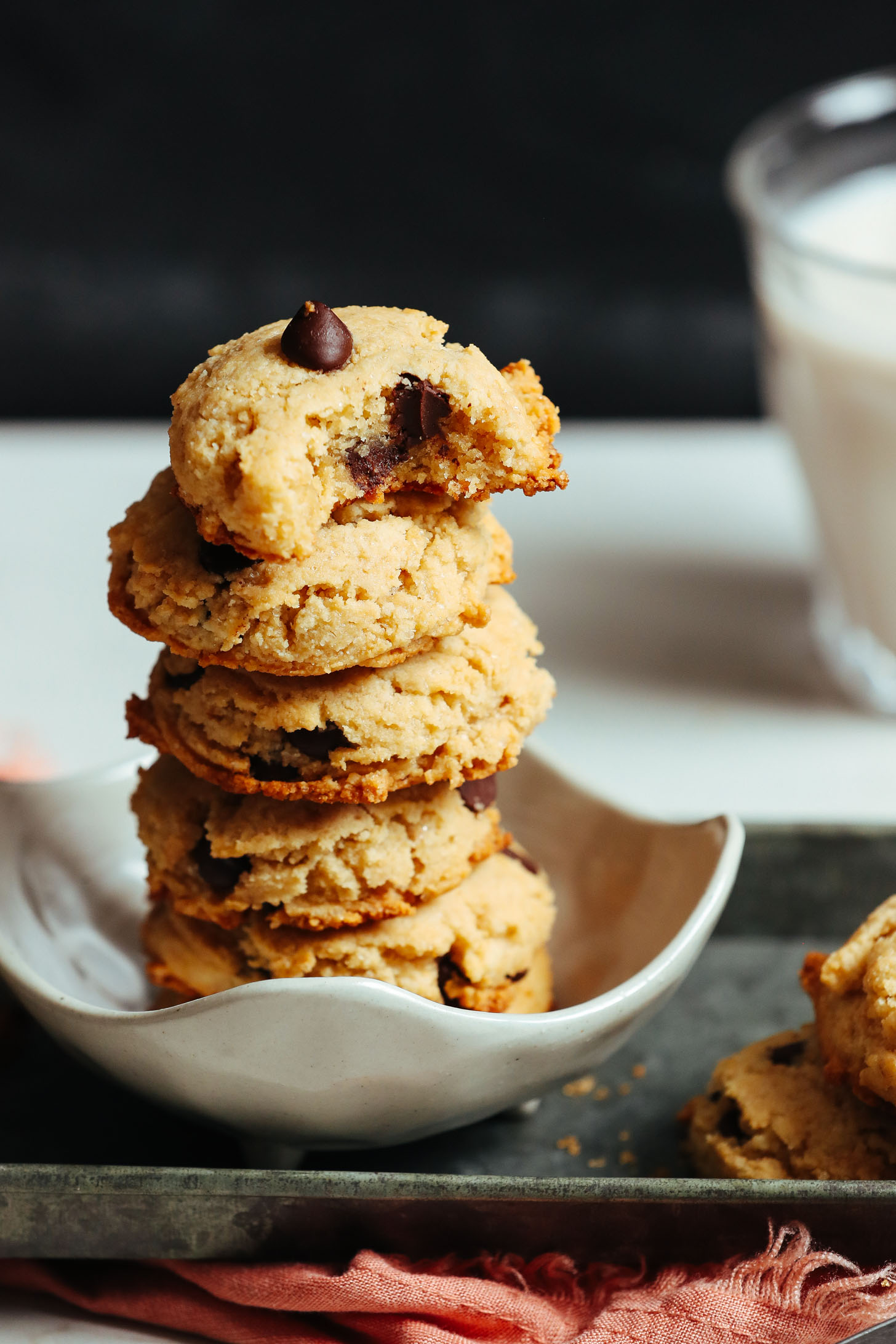 Small bowl with a stack of gluten-free vegan chocolate chip cookies