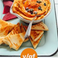Tray of ingredients and tray with a bowl of White Bean Pumpkin Hummus surrounded by sliced beets and pita wedges