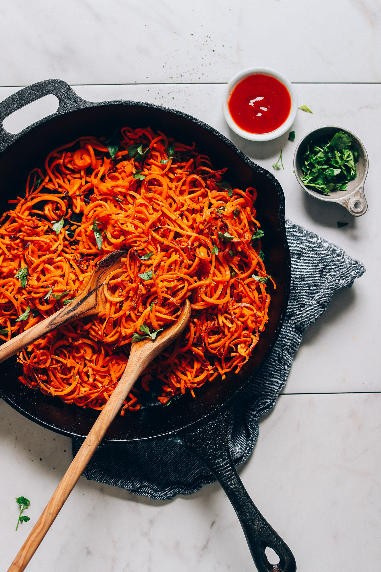 Skillet of vegan Sweet Potato Hashbrowns with sides of parsley and ketchup