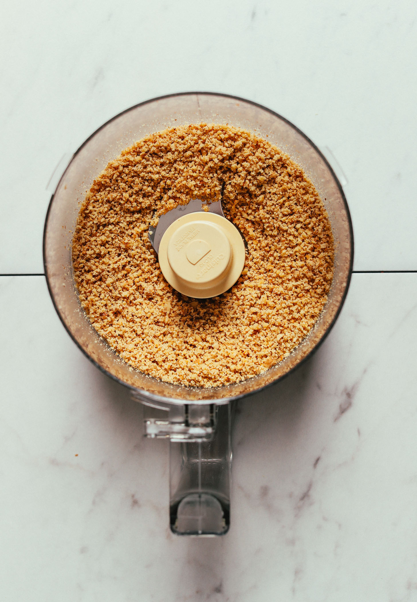 Food processor with ground walnuts for making our Lentil Fesenjan recipe