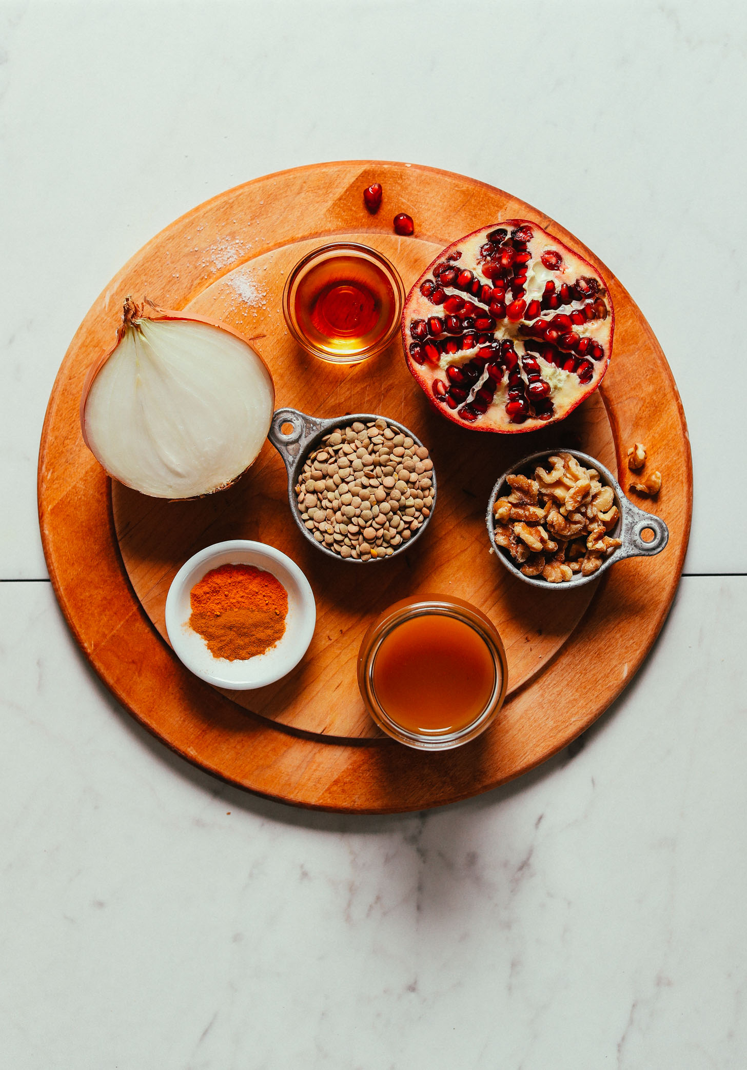 Wood cutting board with ingredients for making satisfying gluten-free vegan Lentil Fesenjan