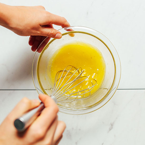 Whisking together ingredients for our easy Lemon Vinaigrette Dressing recipe