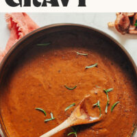Wooden spoon in a pan of our easy vegan gravy with text that says ready in 15 minutes