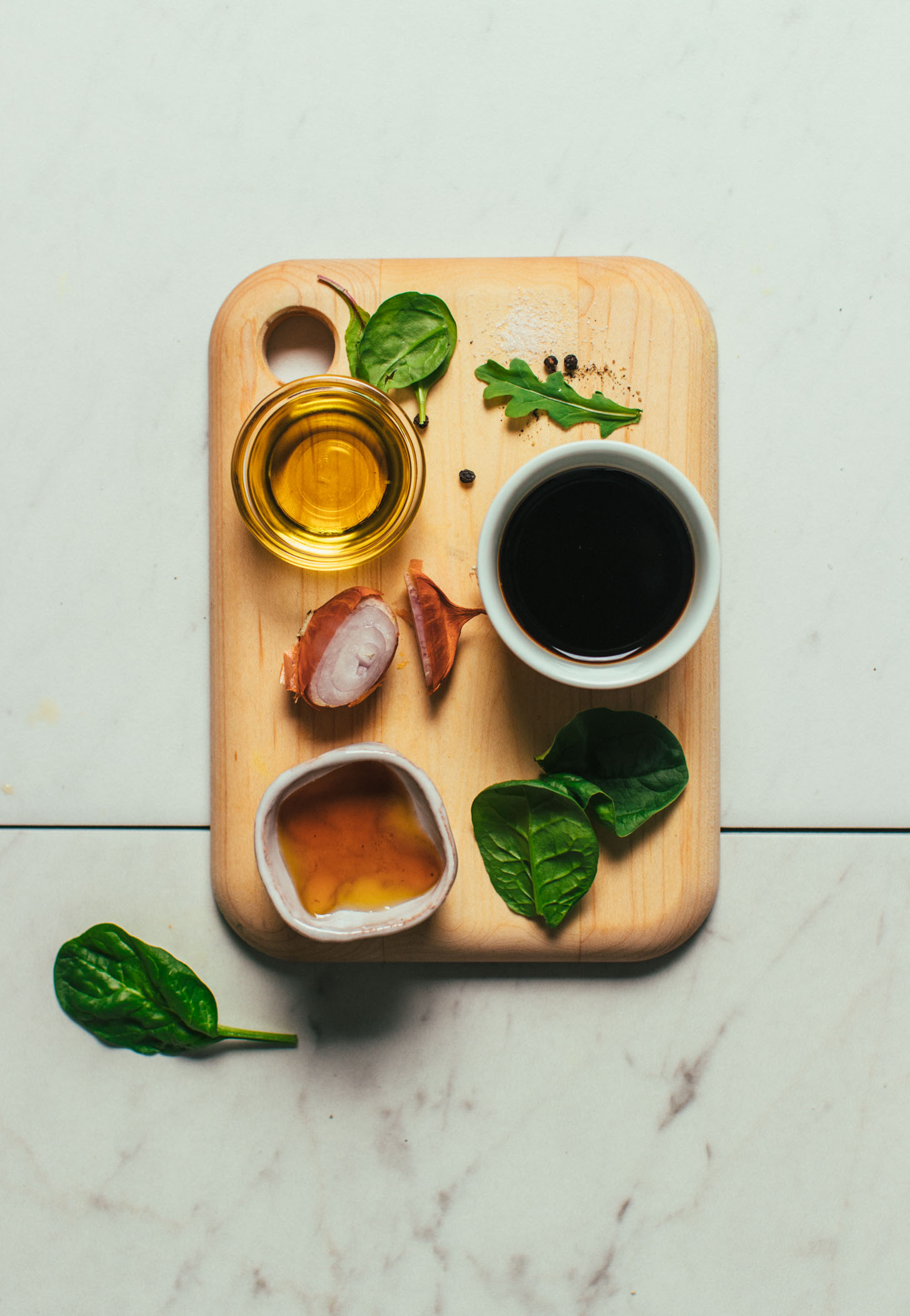 Wood cutting board filled with ingredients for making our balsamic vinaigrette recipe