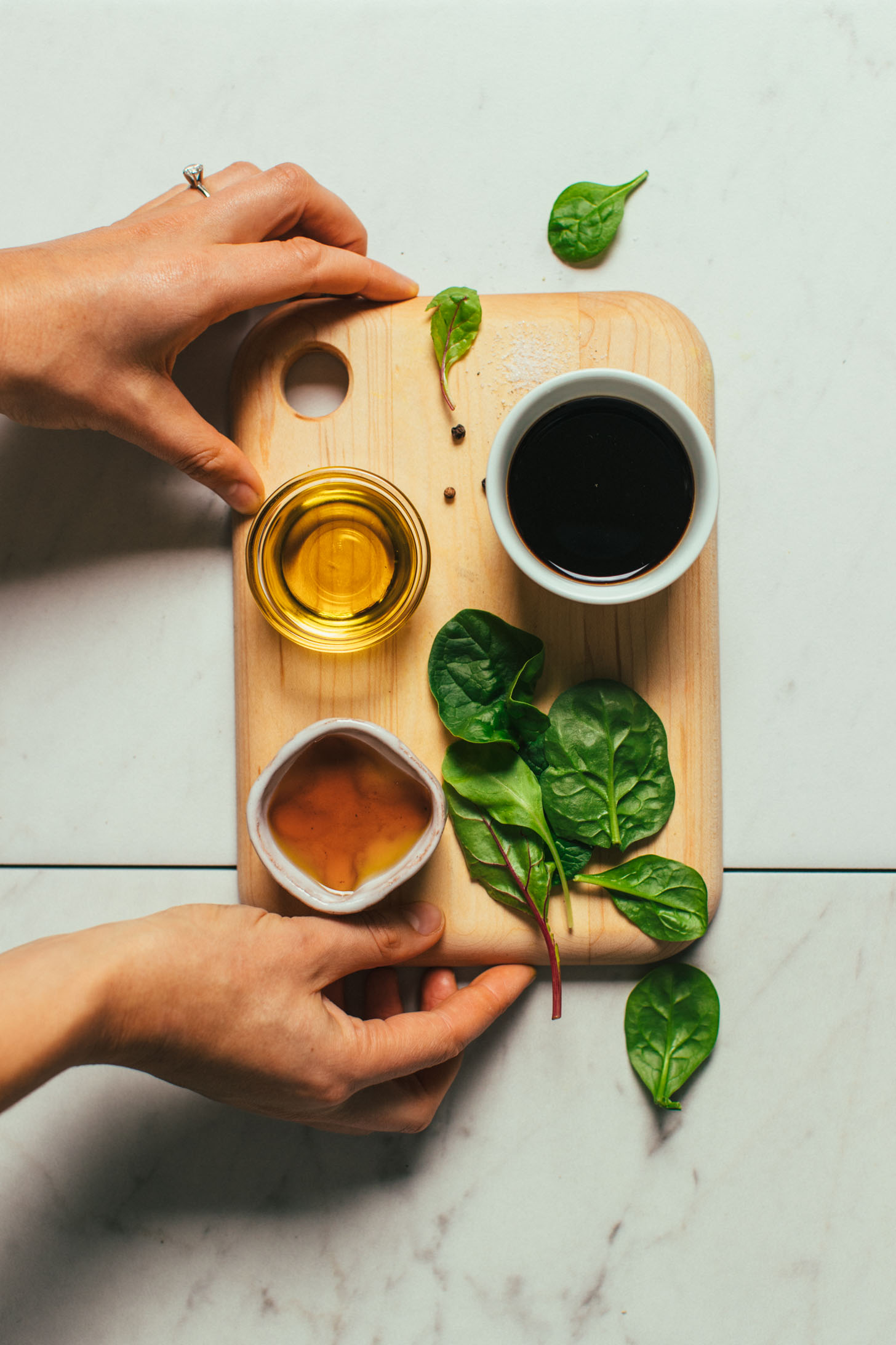 Greens, olive oil, balsamic vinegar, and maple syrup for making a simple Balsamic Vinaigrette recipe