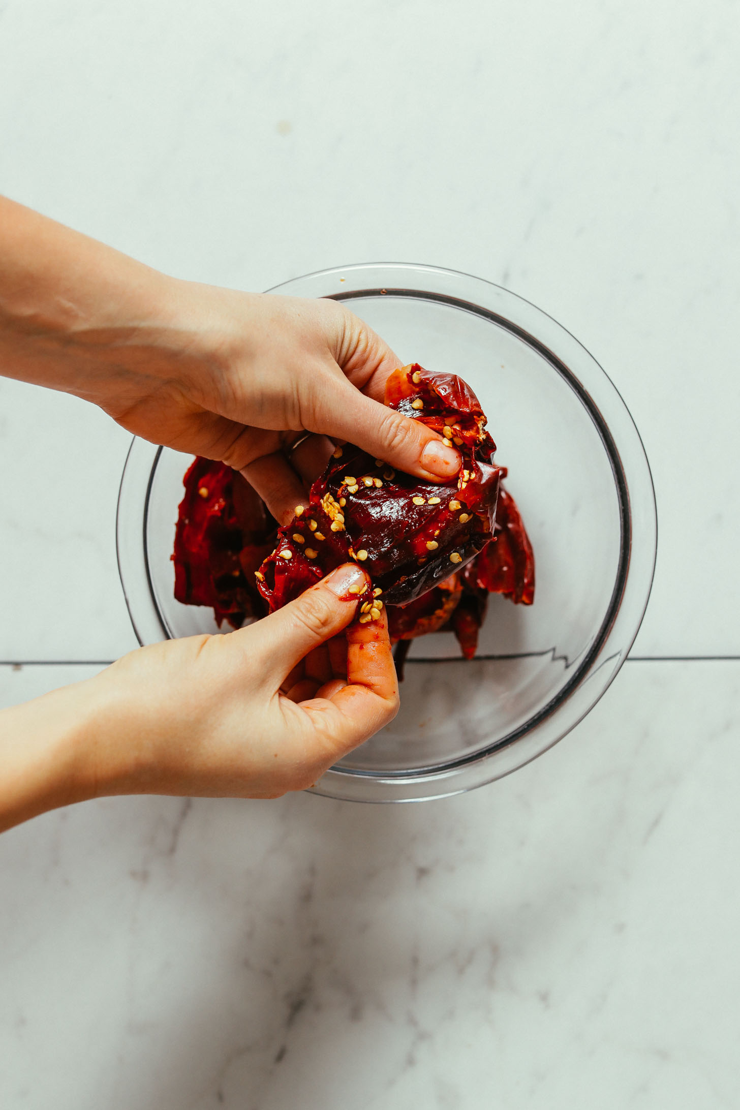 Showing how to remove the seeds from soaked peppers