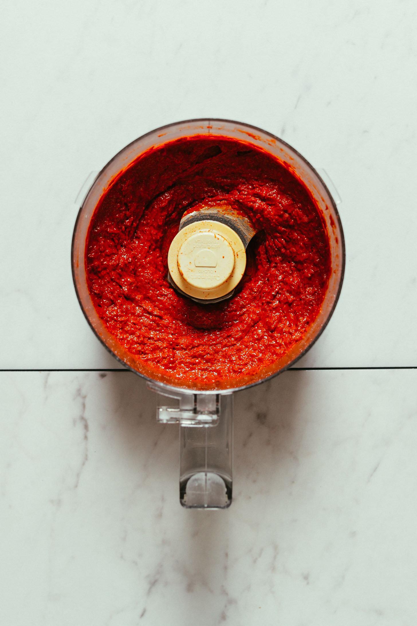 Food processor filled with our freshly blended Harissa Paste