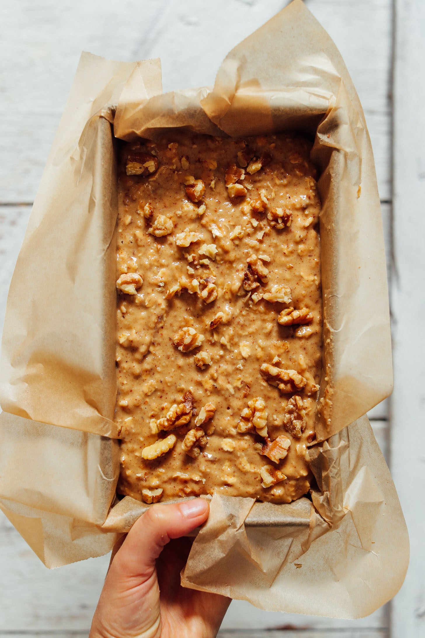 Overhead image of raw banana bread batter about to be baked in the oven