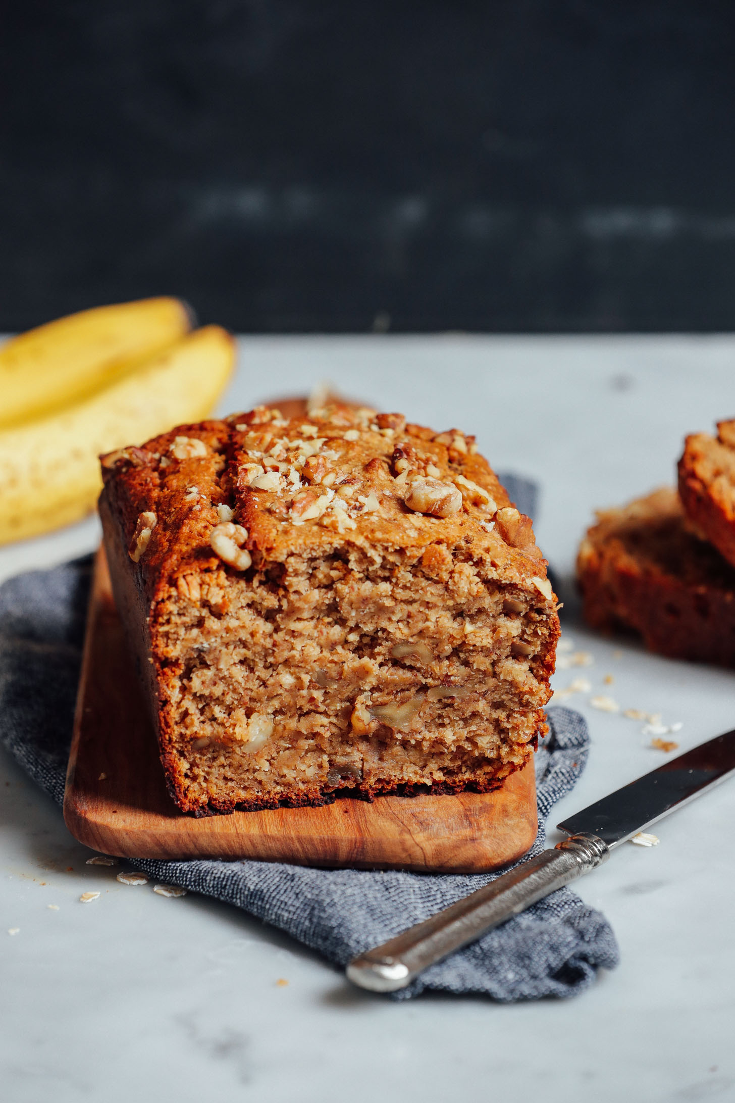 Cutting board with a half loaf of Vegan Gluten-Free Banana Bread