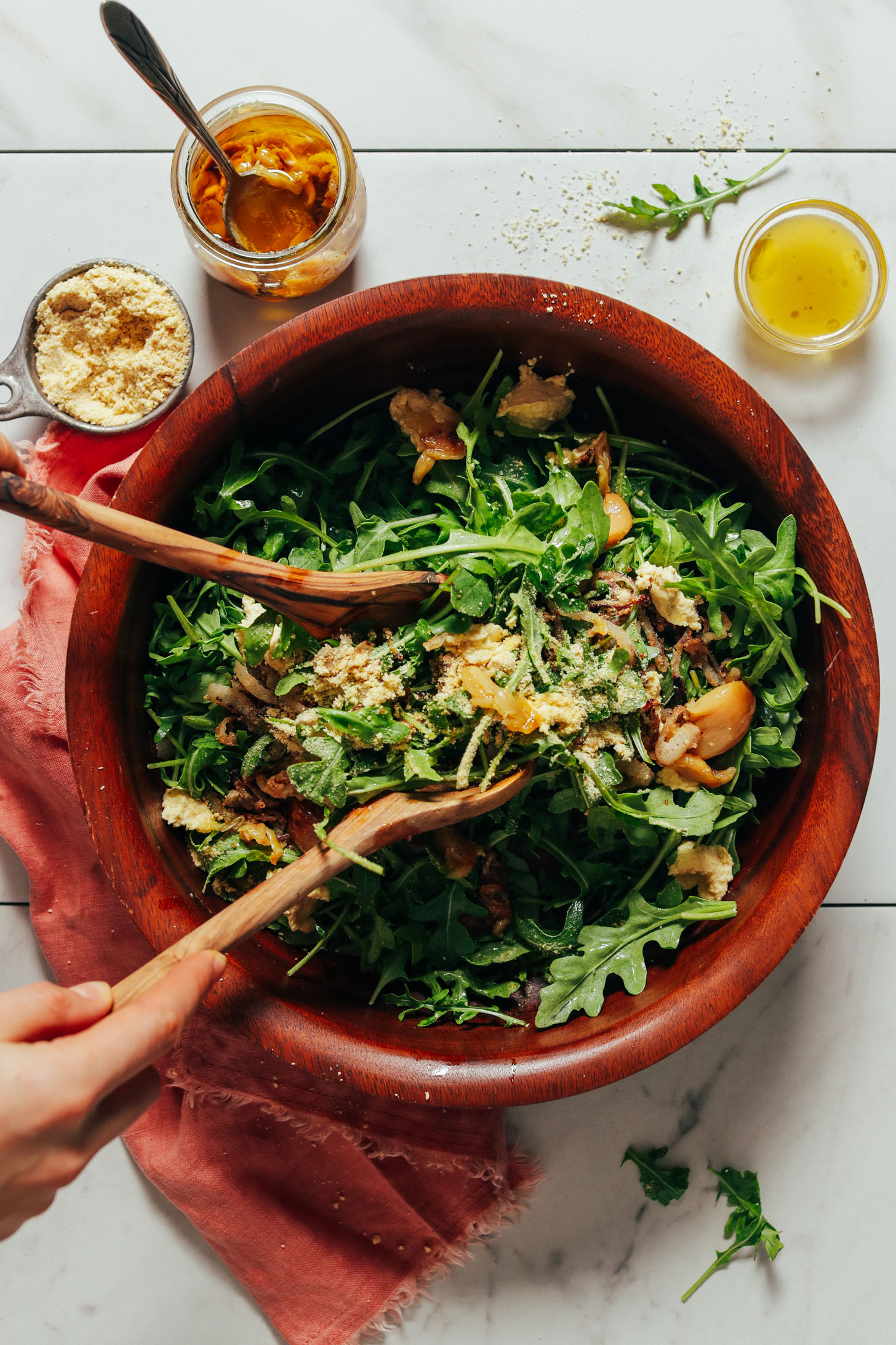 Big bowl of our Lemony Arugula Salad recipe made with crispy shallots and nut cheese
