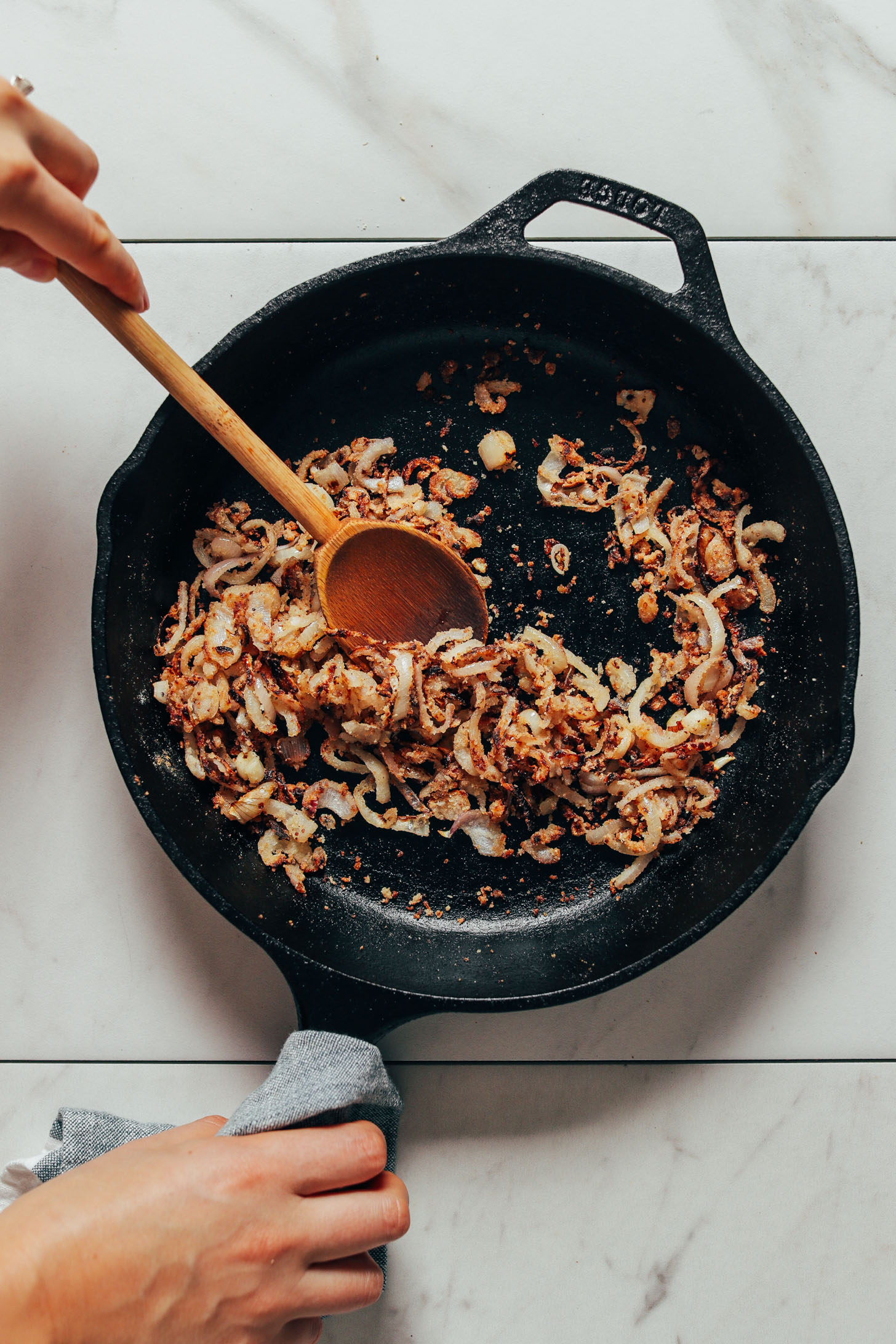 Cooking crispy shallots in a cast iron skillet for our Lemony Arugula Salad recipe