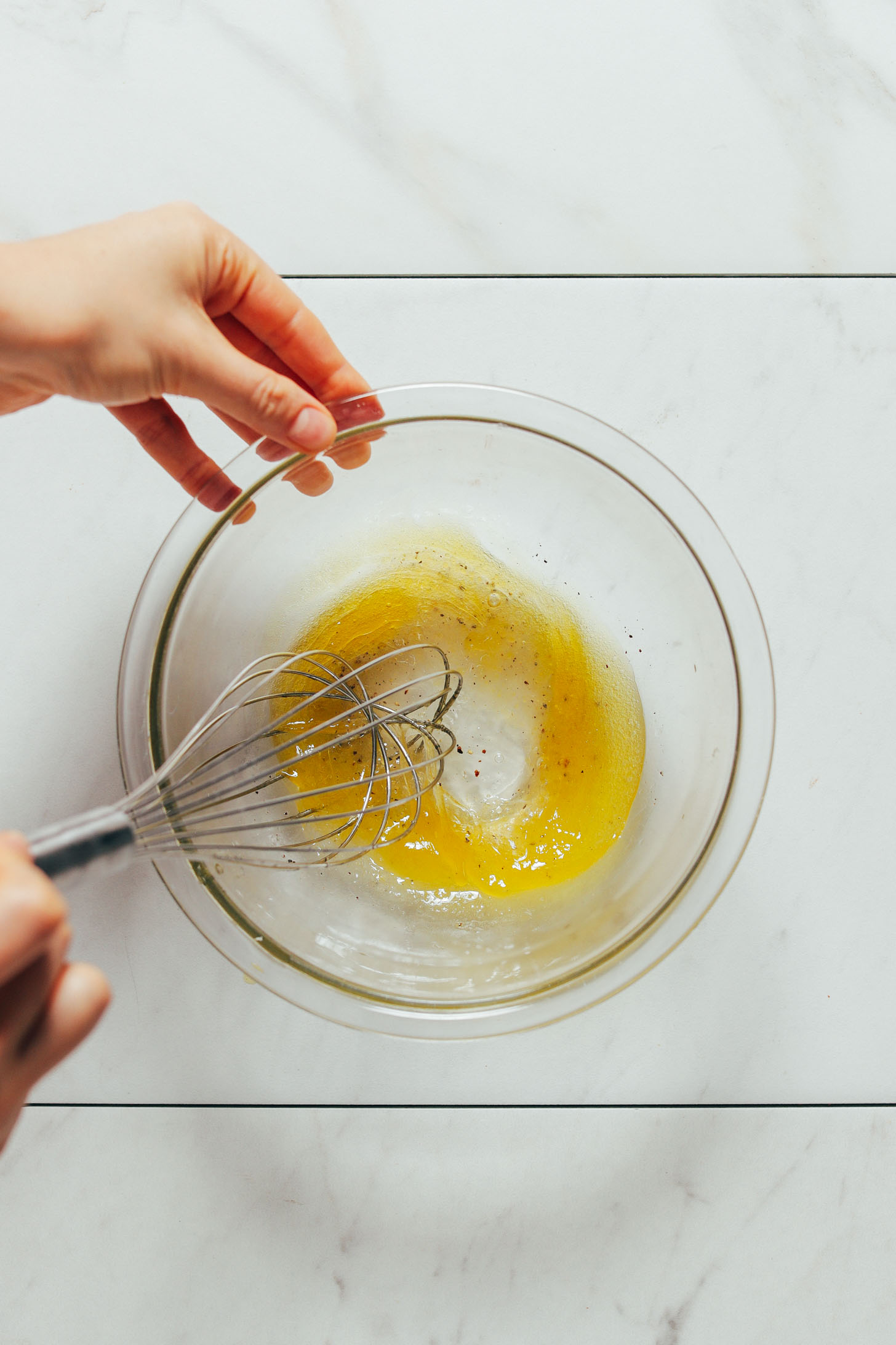 Whisking together ingredients for a simple lemon vinaigrette dressing
