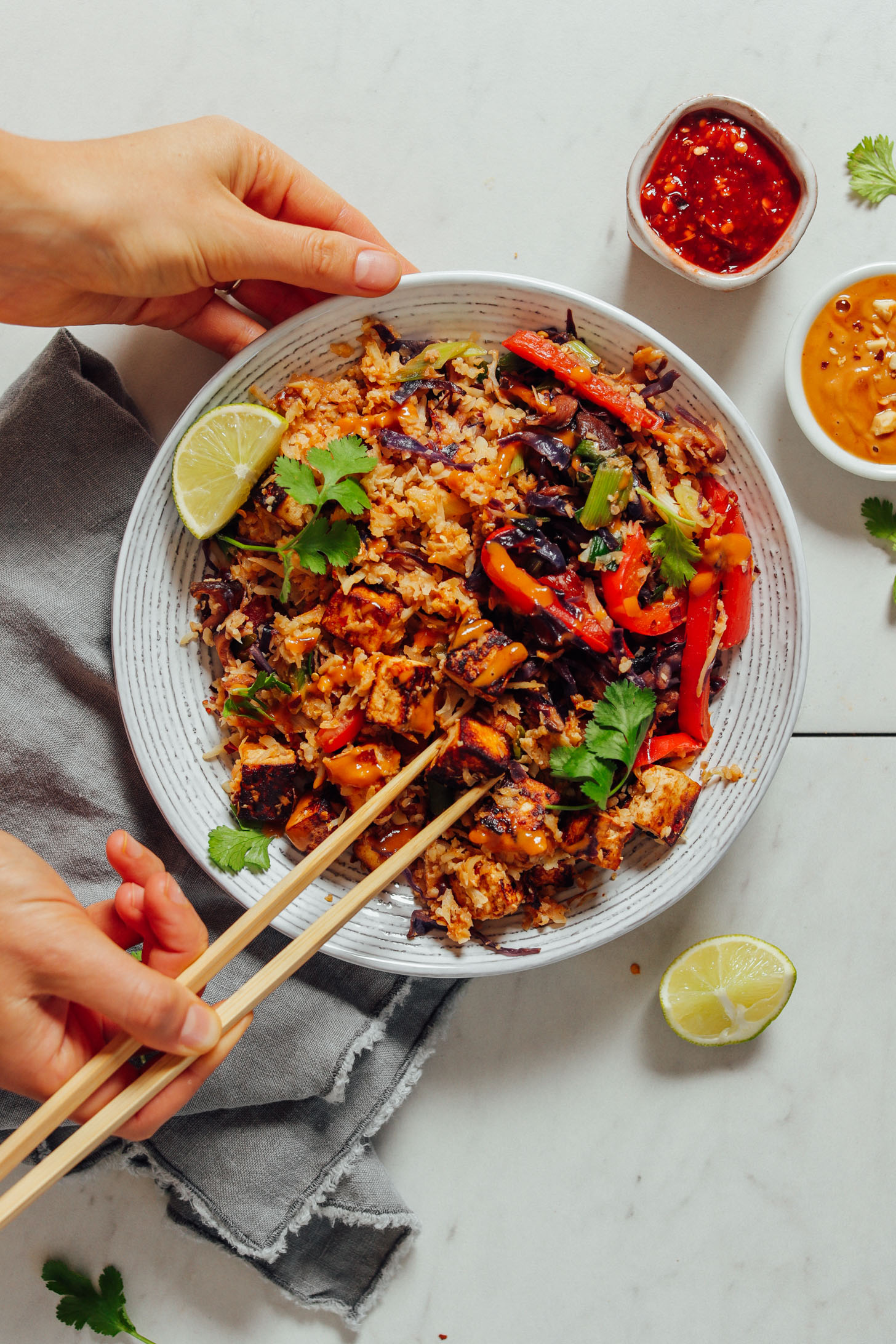 Using chopsticks to pick up a bite of Tofu Stir Fry for a quick grain-free meal