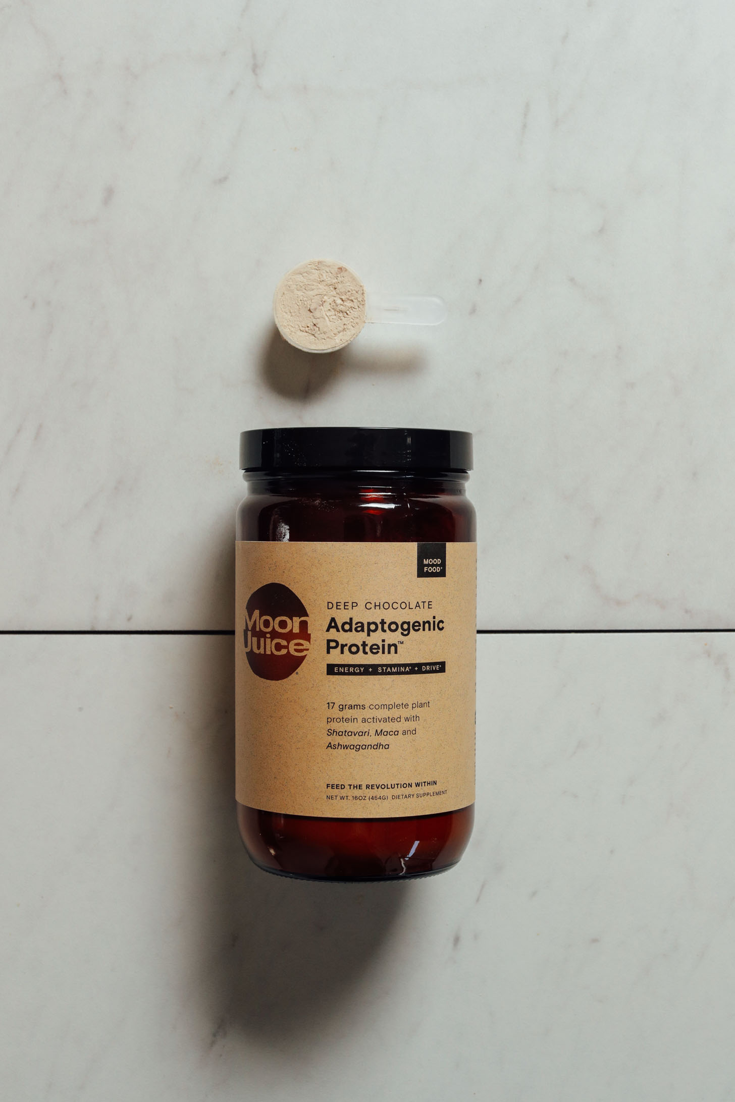 Jar and scoop of Moon Juice Adaptogenic Chocolate Protein Powder