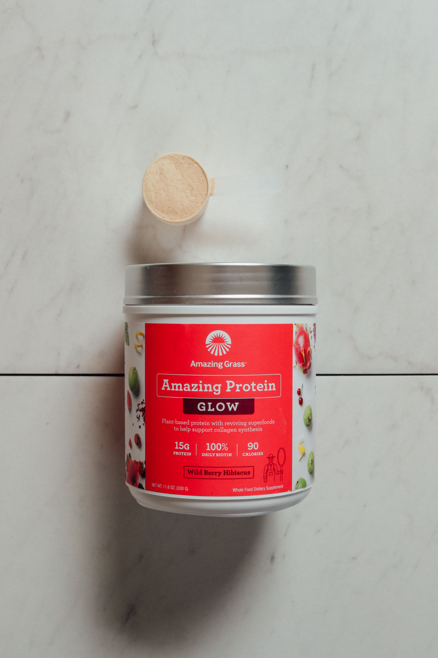 Tub and scoop of Amazing Grass Wild Berry Hibiscus Protein Powder for our review