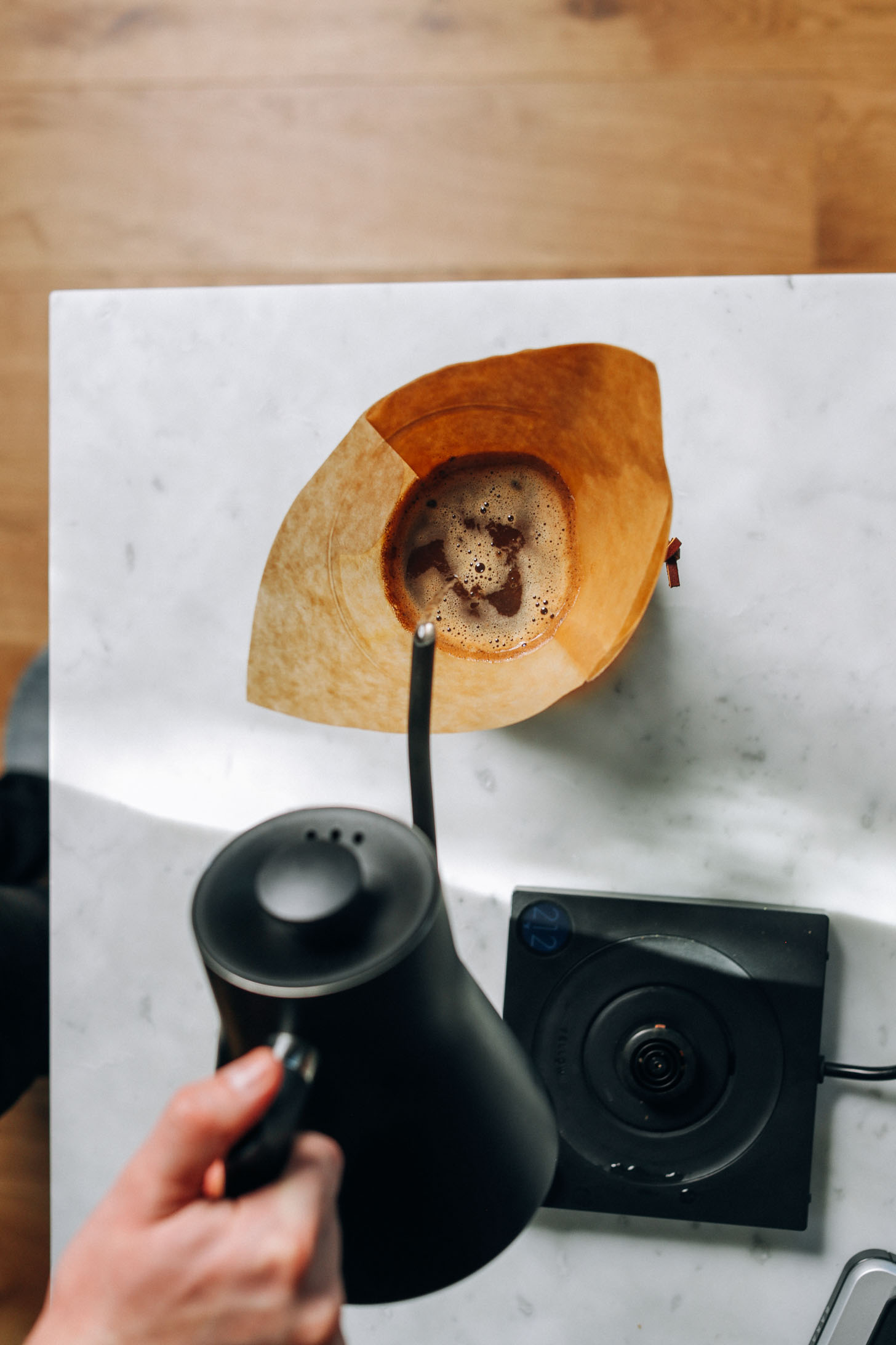 Pouring hot water into a drip coffee maker