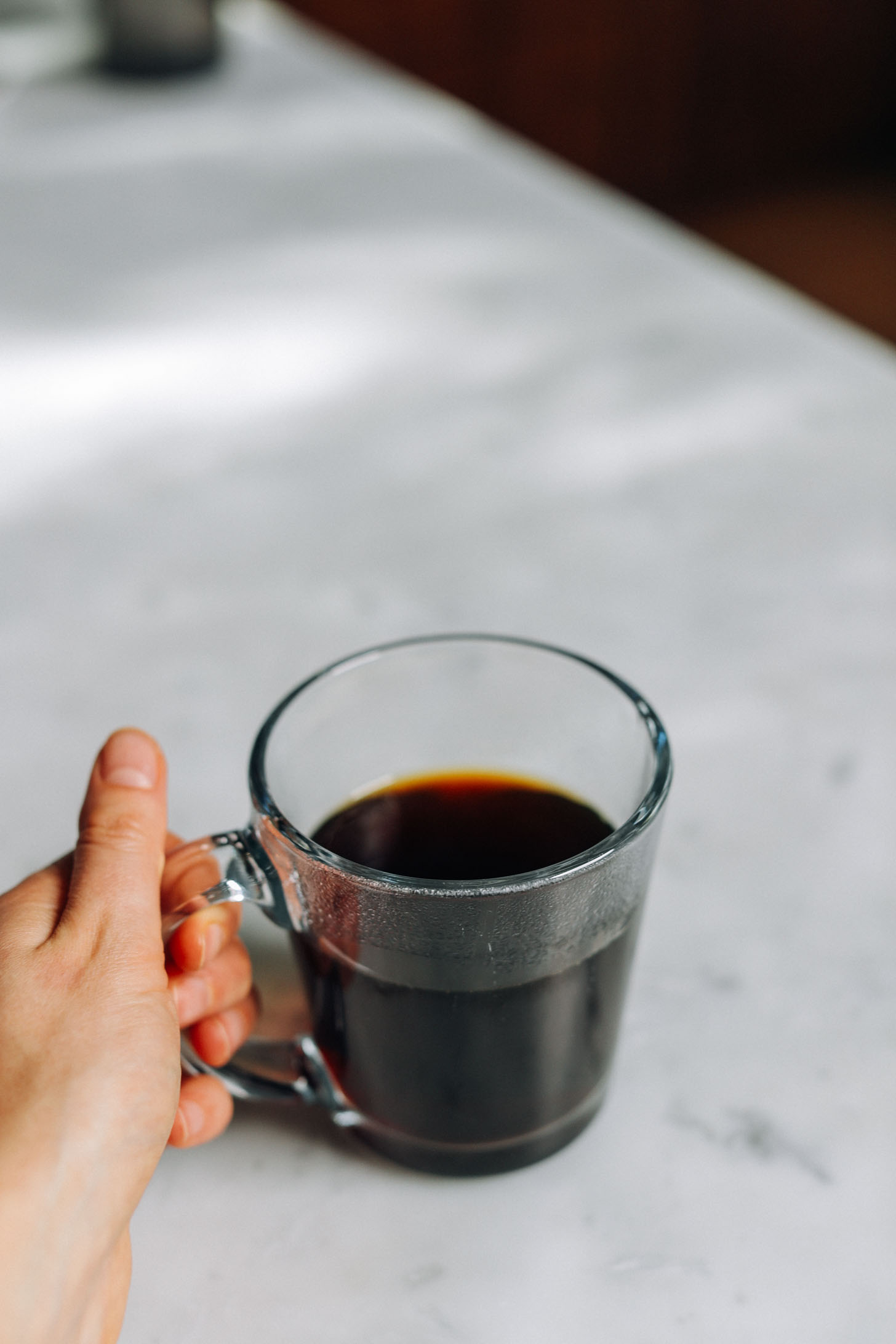 Holding the handle of a mug of coffee