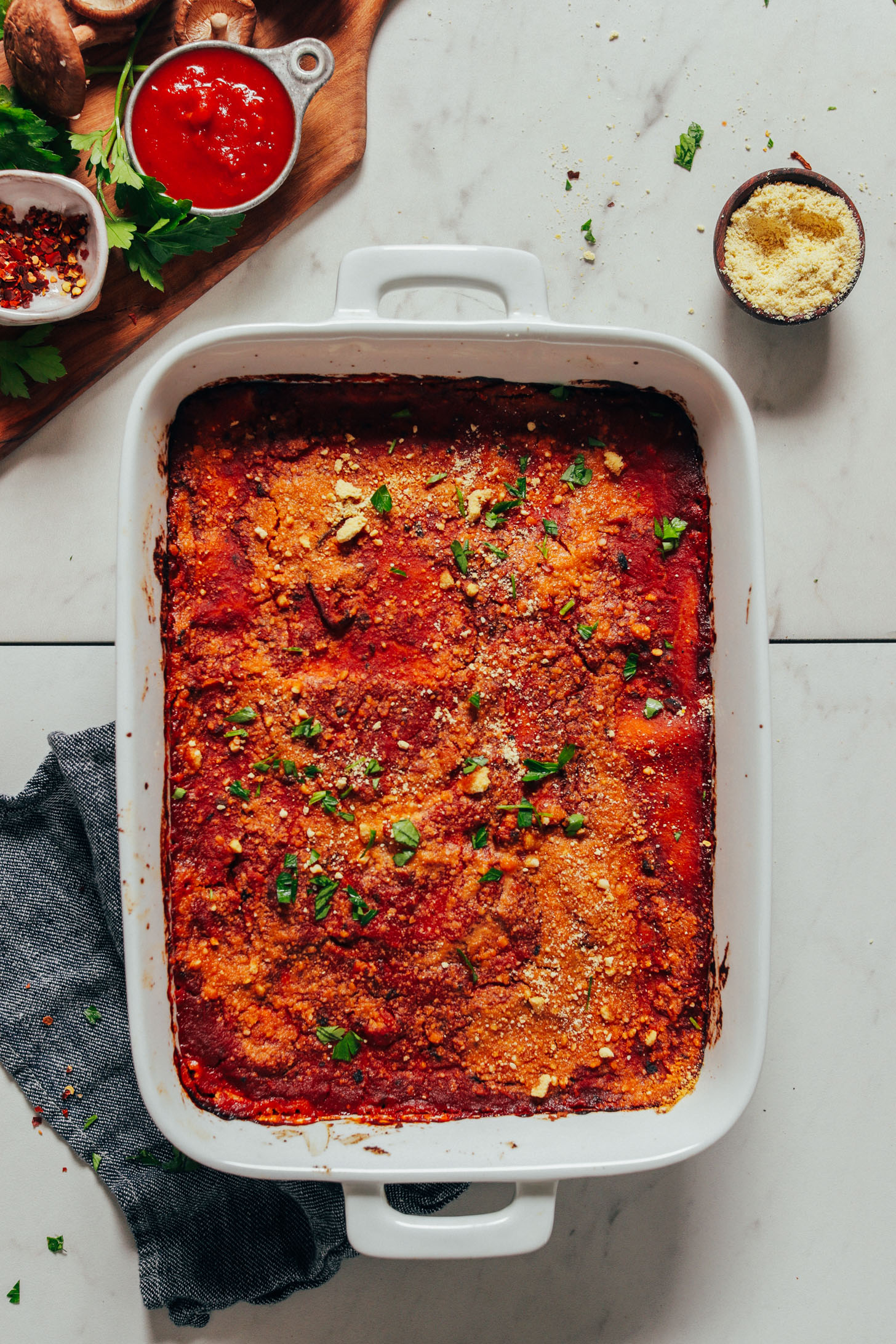 White ceramic dish filled with Classic Vegan Lasagna topped with fresh parsley