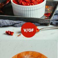 Cutting board of ingredients and bowl of Easy DIY Harissa Paste