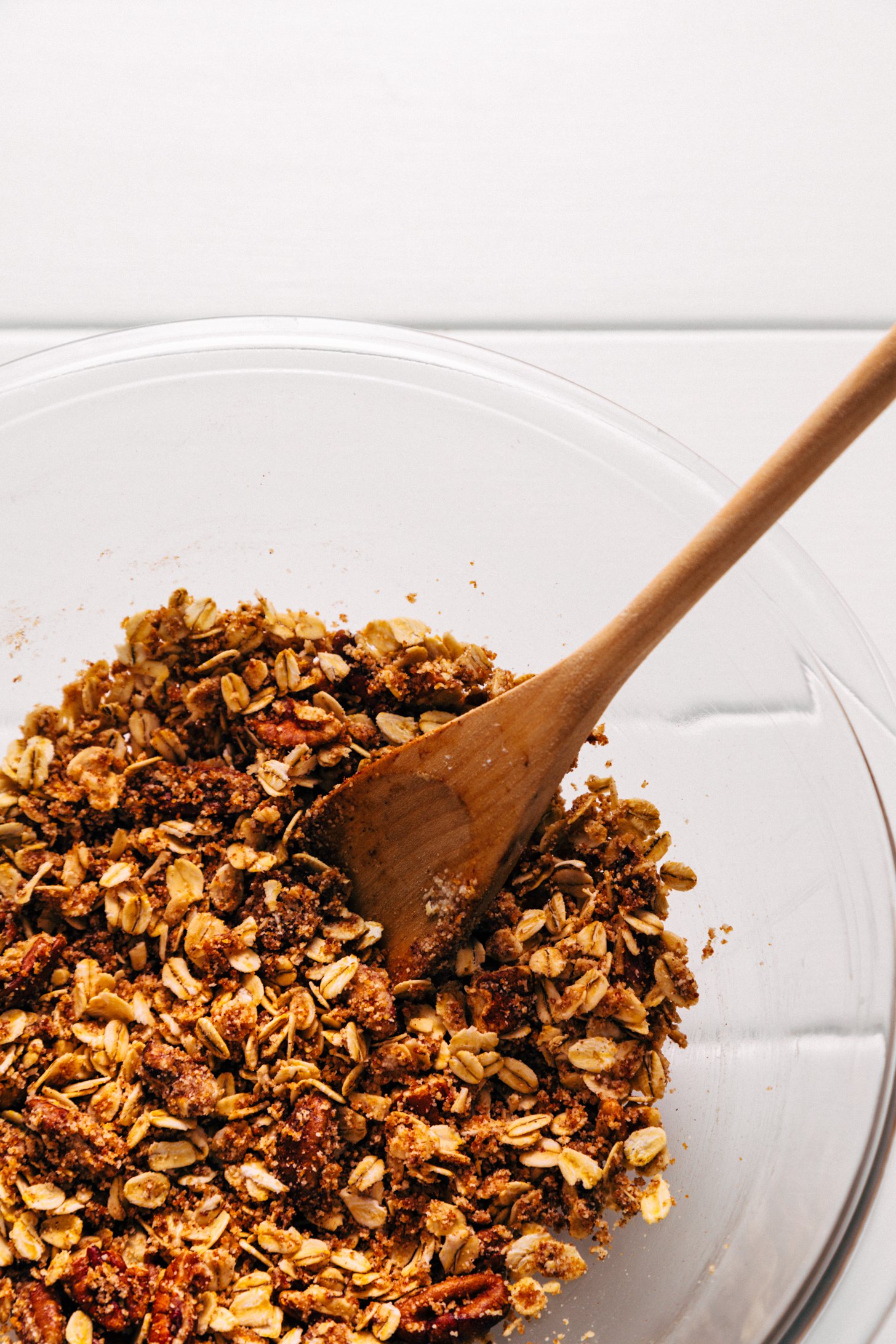 Using a wooden spoon to stir the Pecan-Oat Topping for our Healthified Apple Crisp recipe