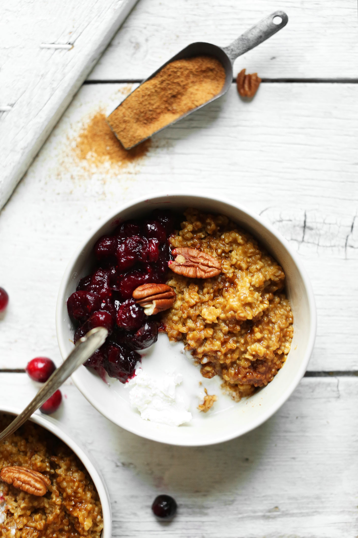 Bowls of Cranberry Pumpkin Steel Cut Oats topped with pecans