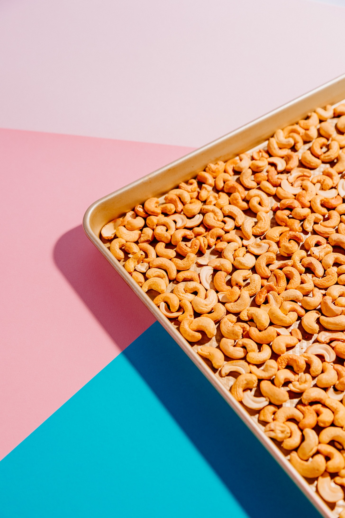 Baking sheet of freshly roasted cashews for making Tropical Trail Mix
