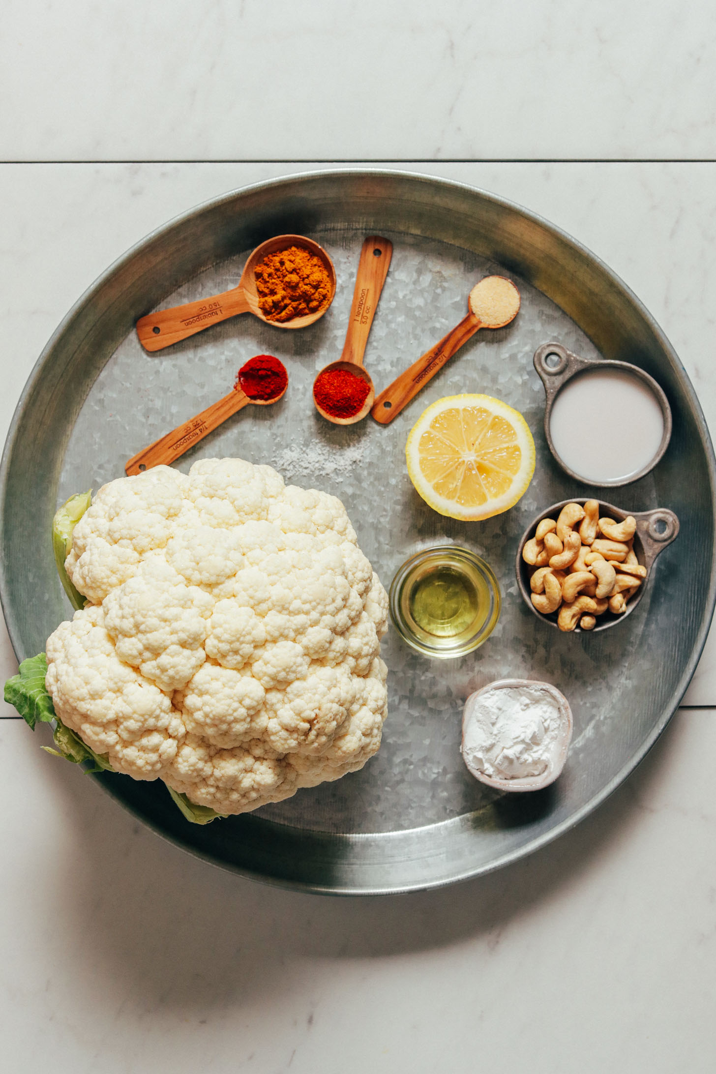 Metal tray filled with ingredients for making our Vegan Crusted Cauliflower Steaks recipe