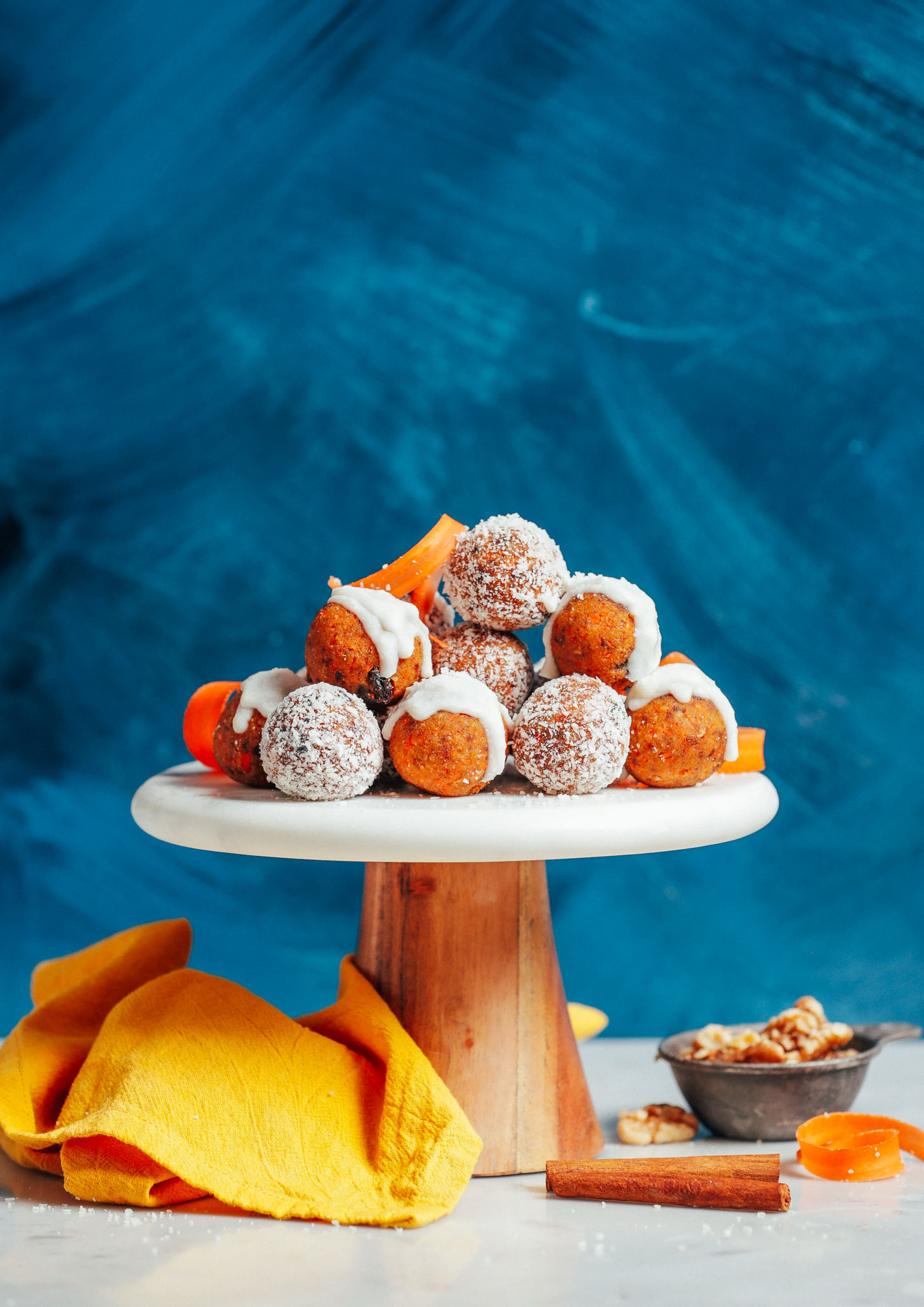 Raw Carrot Cake Bites resting on a cake platter