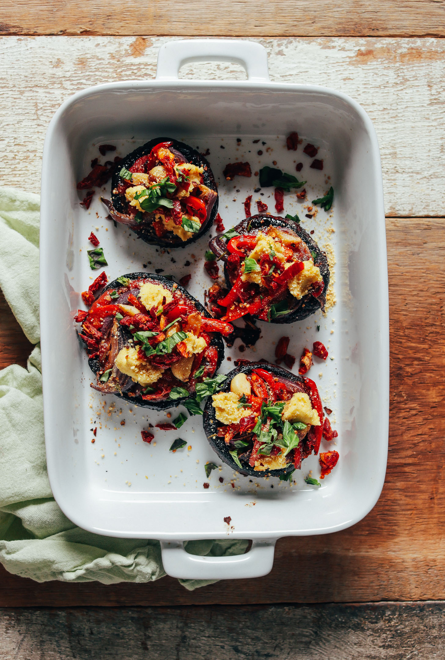 White baking dish filled with Balsamic-Marinated Portobello Pizzas for a delicious vegan meal