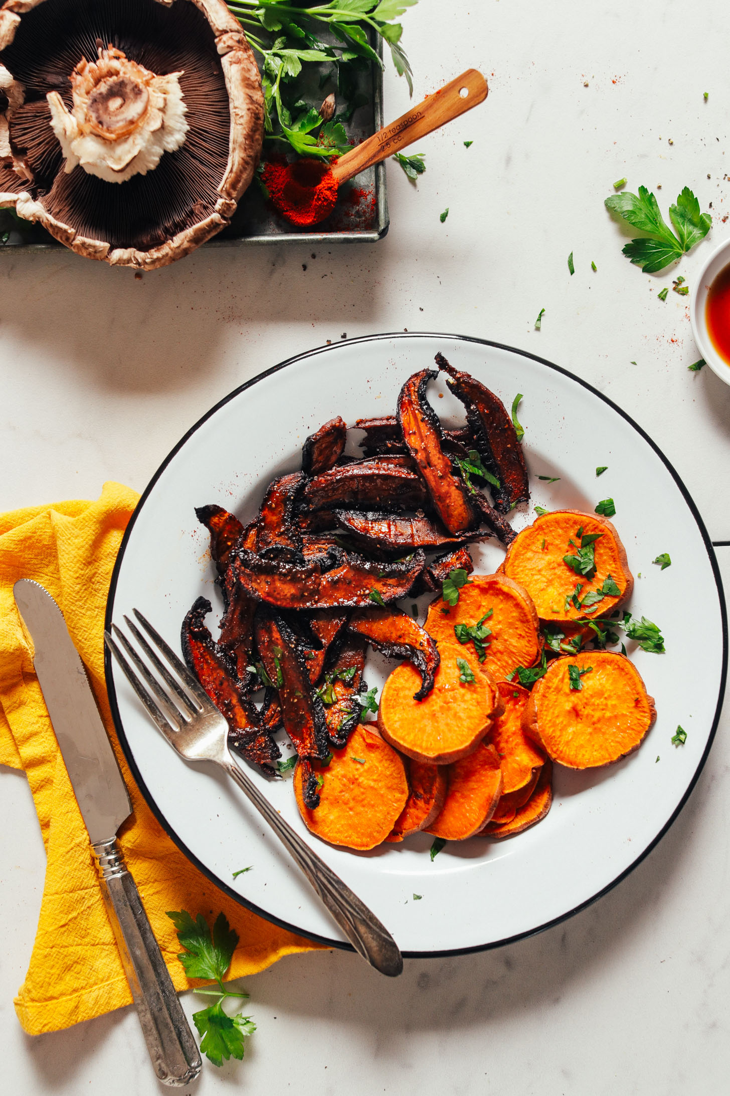 Plate of freshly baked sweet potatoes and Portobello Bacon topped with fresh parsley