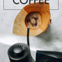 Overhead shot of a gooseneck kettle pouring water into a chemex coffee maker