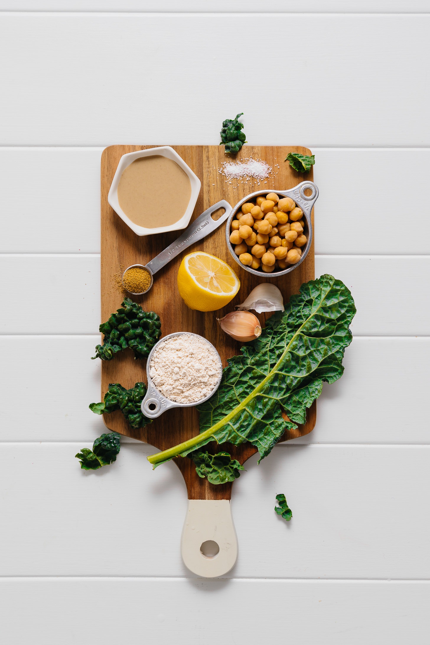 Cutting board with ingredients for making our Kale Falafel Hummus Wraps recipe