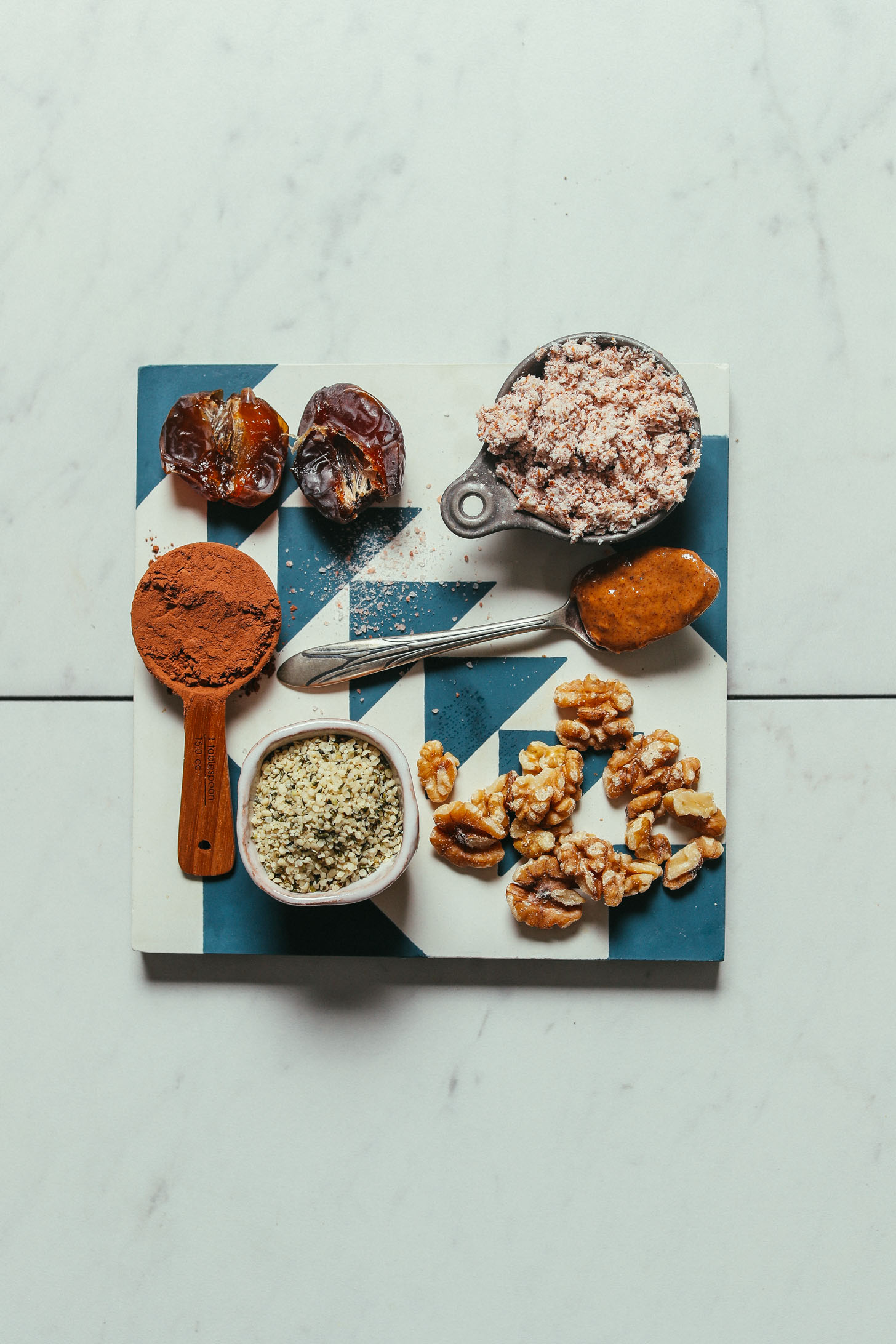Tile with ingredients for making our grain-free Brownie Bliss Balls recipe