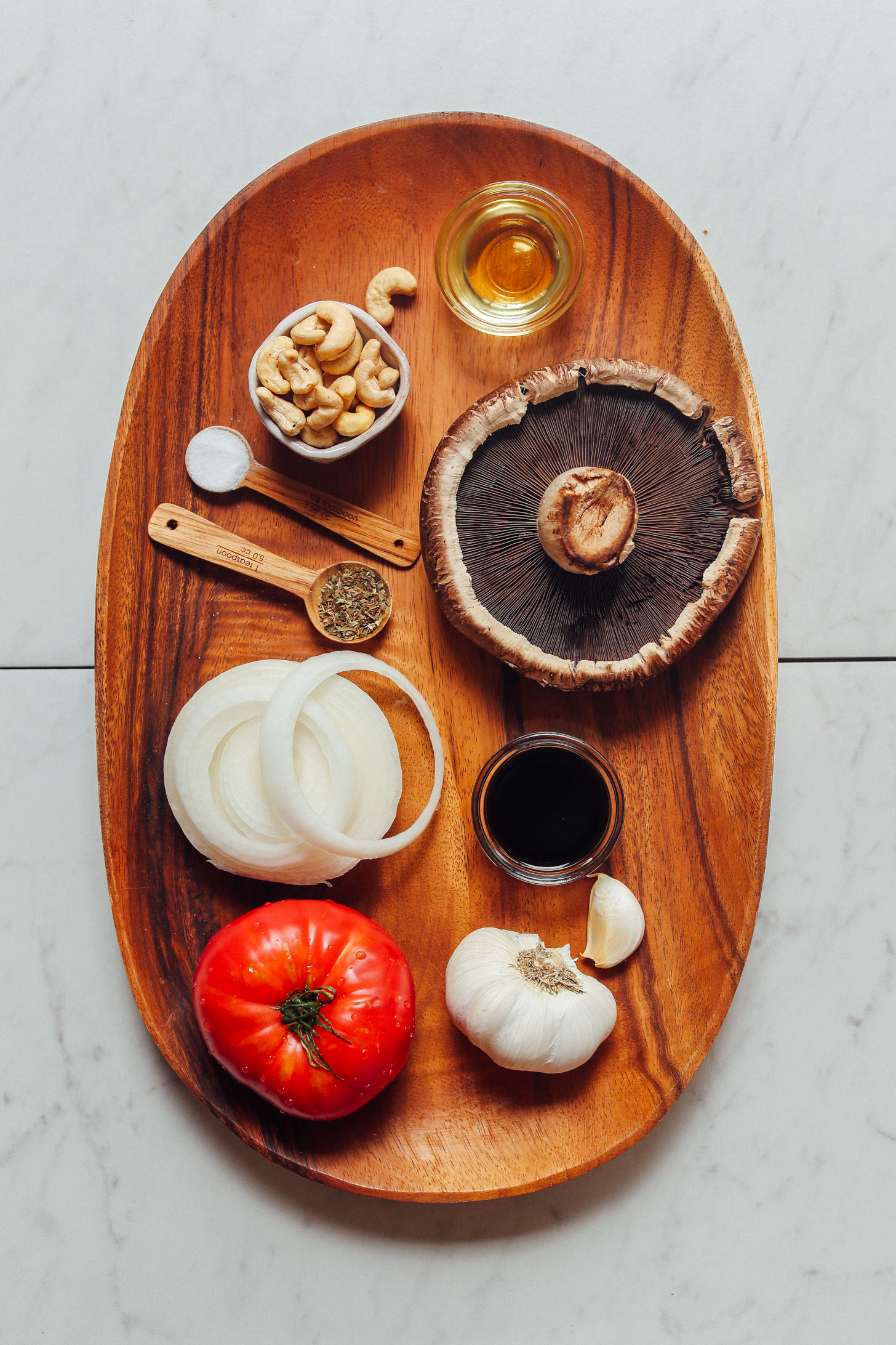 Wood tray filled with ingredients for making homemade Balsamic Marinated Portobello Burgers with Caramelized Onions