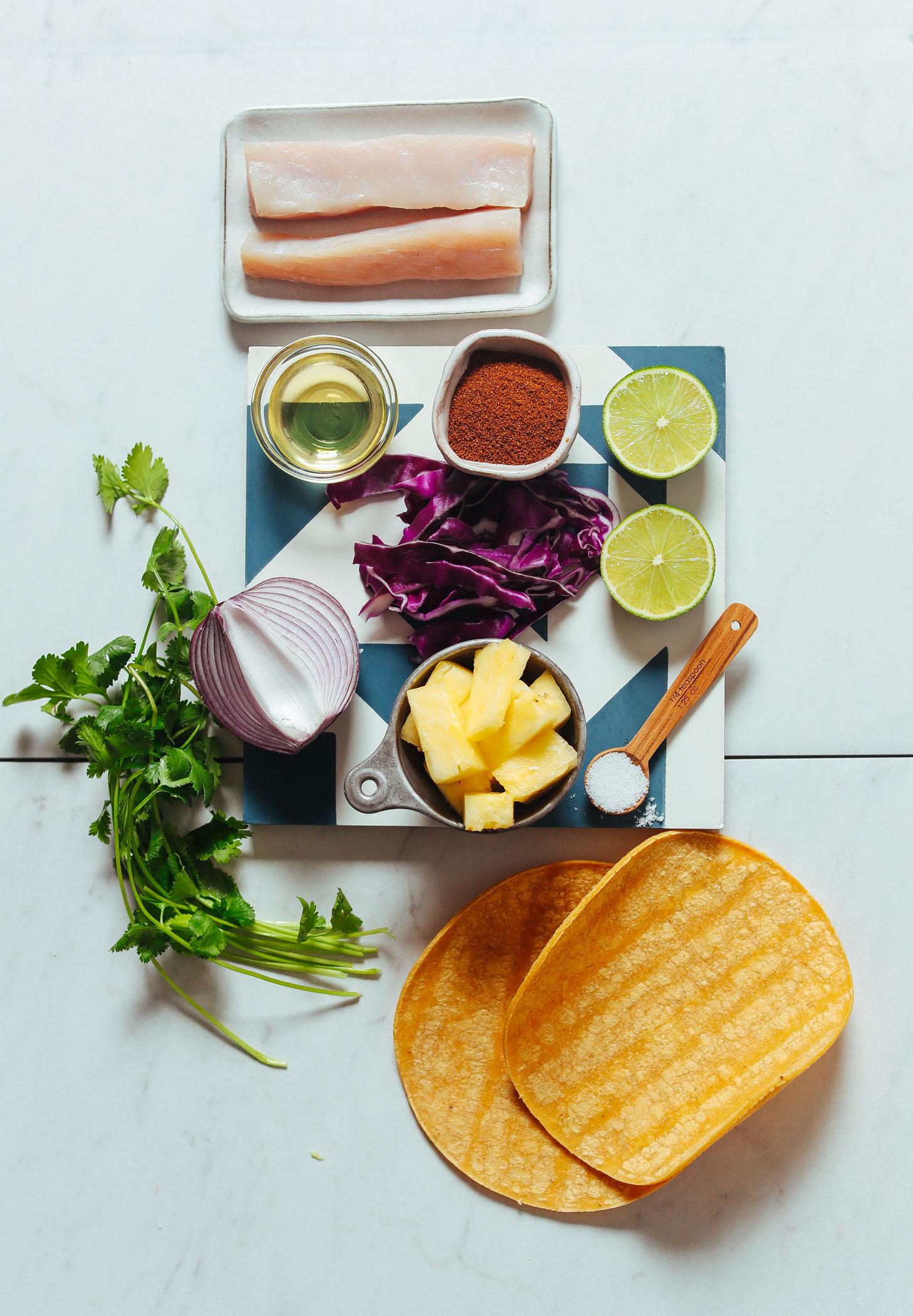 Assortment of ingredients for making Grilled Fish Tacos with Pineapple Cabbage Slaw