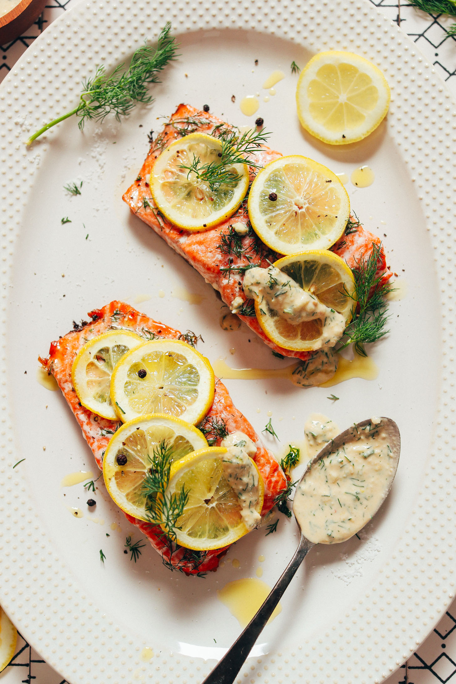 Platter with Dill & Lemon Salmon beside a spoonful of Quick Garlic Sauce