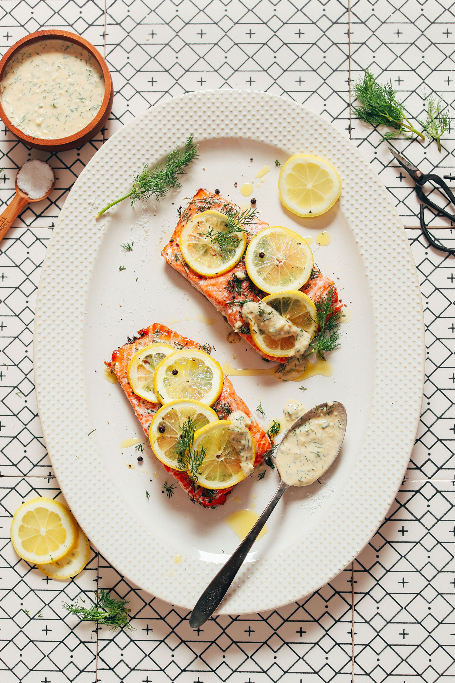Platter with Dill & Lemon Salmon with a bowl and spoon of Garlic Dill Sauce