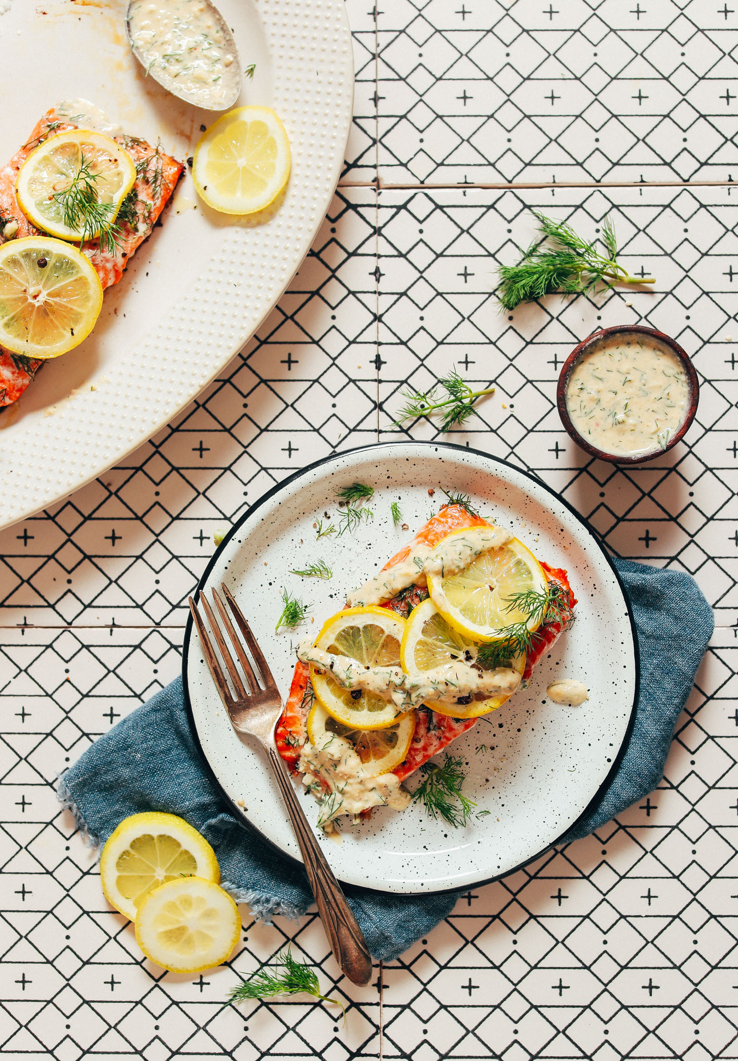 Platter and plate of Dill & Lemon Salmon topped with Garlic Dill Sauce