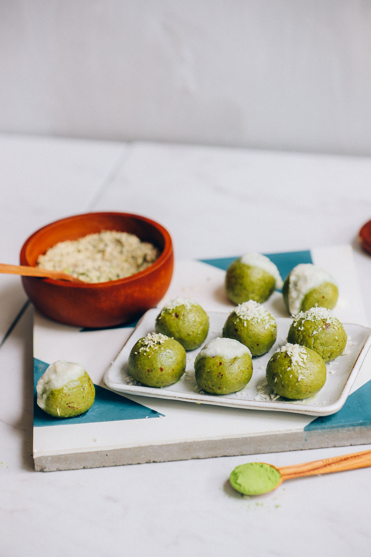 Bowl of hemp seeds next to a tray of Matcha Bliss Balls