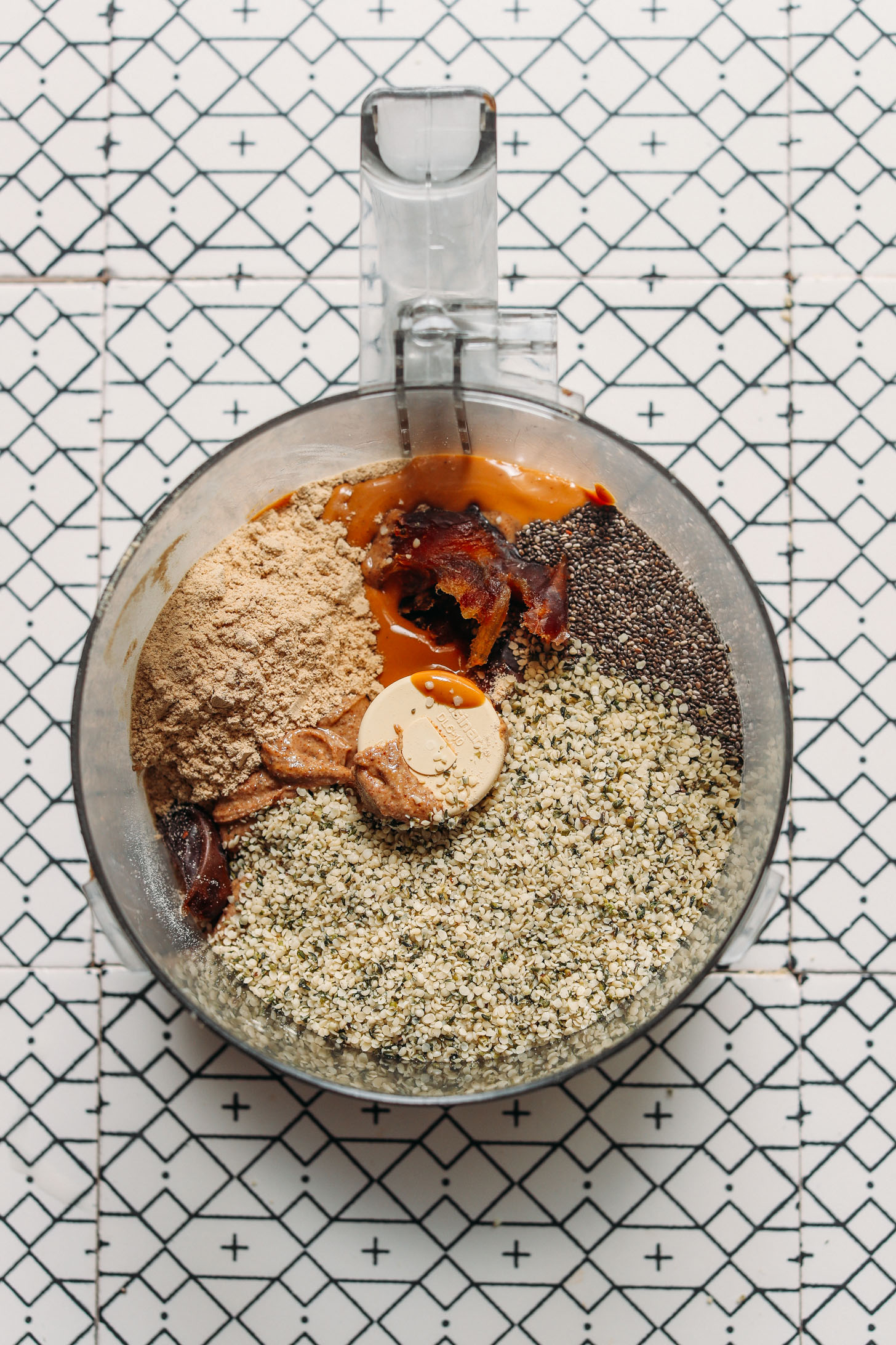 Food processor filled with ingredients for making our grain-free Protein Balls for a low sugar snack
