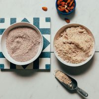 Two bowls of almond meal with one made from leftover almond pulp