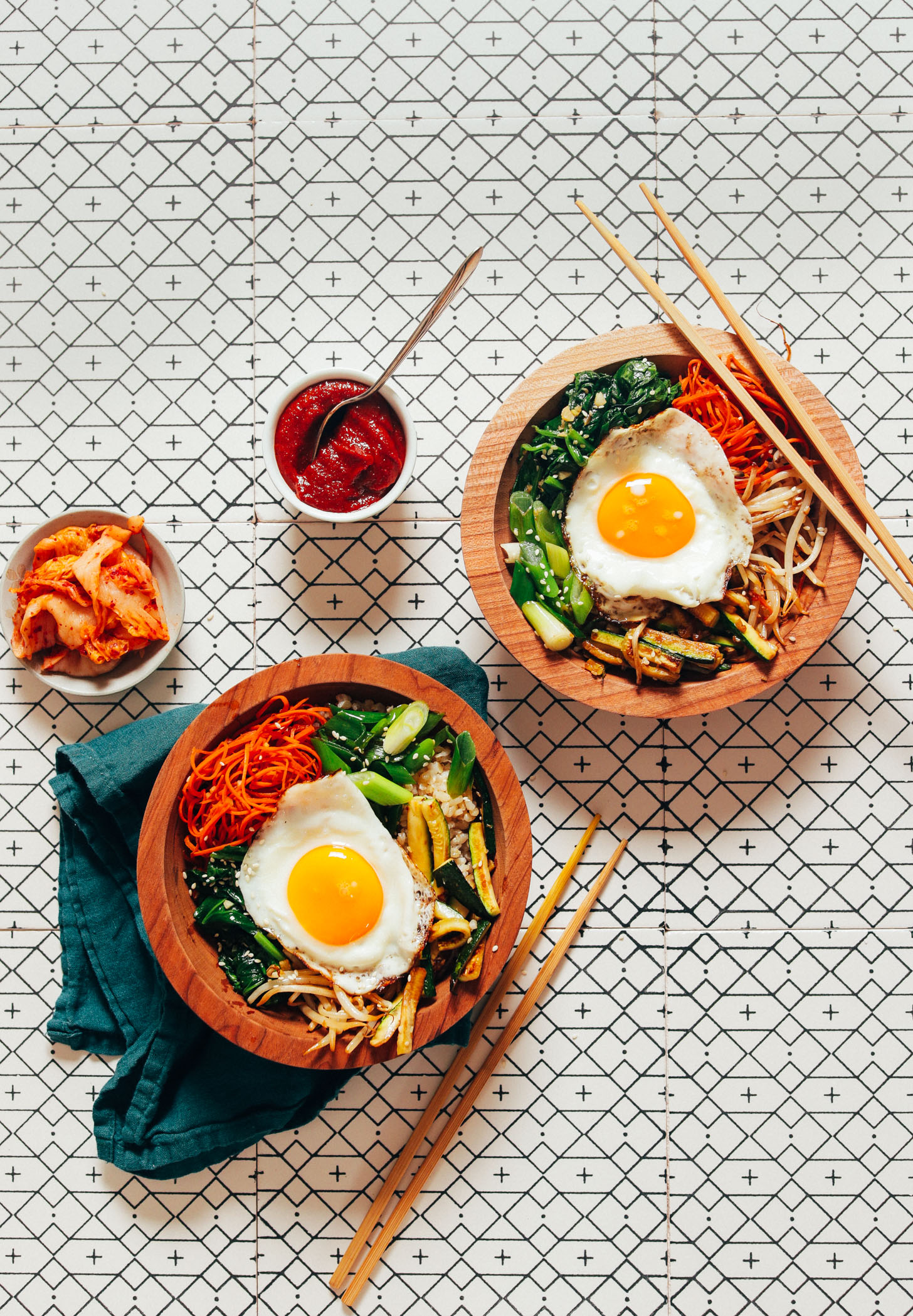 Bowls of homemade Korean Bibimbap with kimchi and Gochujang sauce