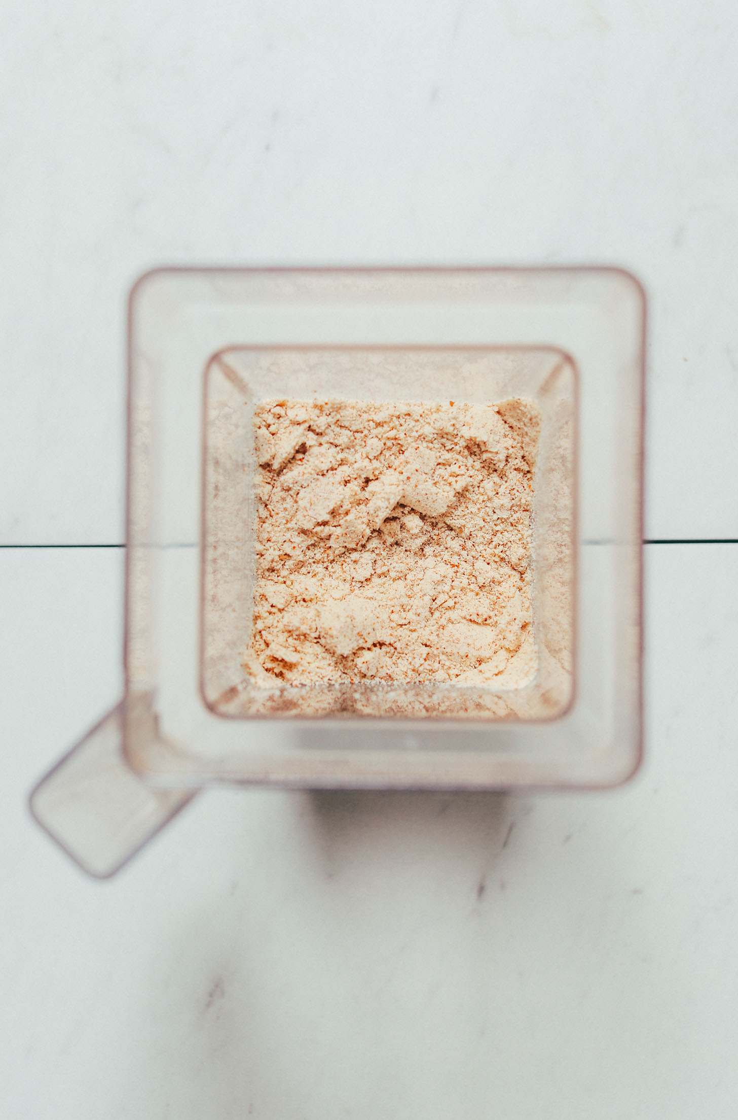 Blender filled with homemade almond meal
