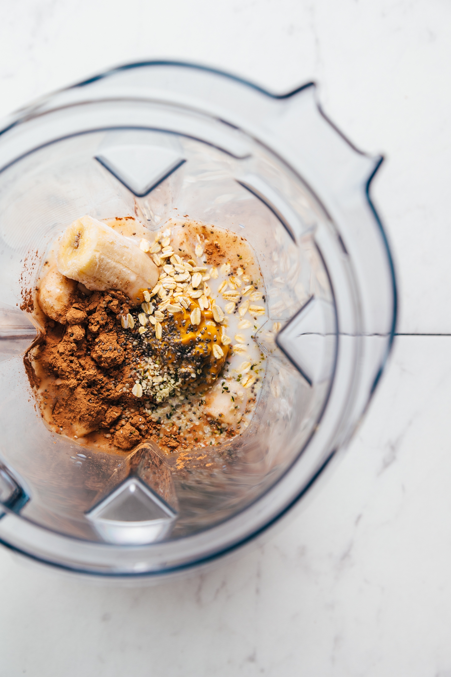 Blender filled with ingredients for making our delicious real food Chocolate Protein Shake