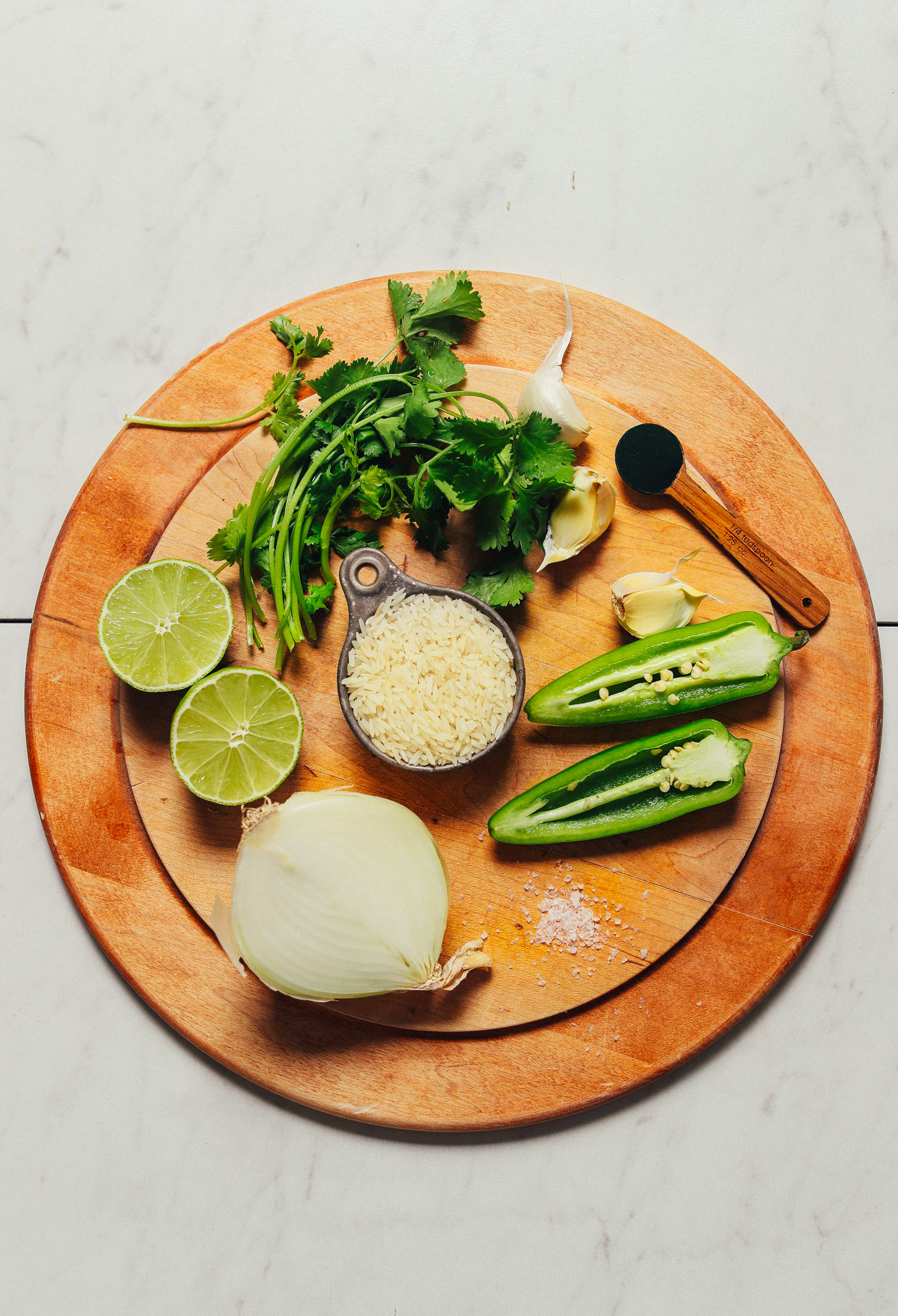 Wood cutting board with ingredients for making our Mexican-inspired Green Rice recipe